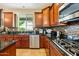 This kitchen features cherry cabinets, stainless appliances, a tiled backsplash, and granite counters at 5136 W Trotter Trl, Phoenix, AZ 85083