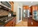 The kitchen features cherry cabinets, stainless appliances, a tiled backsplash, and granite counters at 5136 W Trotter Trl, Phoenix, AZ 85083