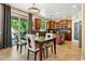 Open kitchen with cherry cabinets, stainless appliances, granite counters, and a dining table with seating for six at 5136 W Trotter Trl, Phoenix, AZ 85083