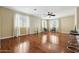 Bright living room featuring hardwood floors, ceiling fan, and natural light at 5136 W Trotter Trl, Phoenix, AZ 85083