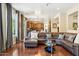 Comfortable living room with hardwood floors, a sectional sofa, and an open view to the kitchen at 5136 W Trotter Trl, Phoenix, AZ 85083