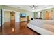 Bright main bedroom featuring hardwood floors, ceiling fan, and natural light at 5136 W Trotter Trl, Phoenix, AZ 85083