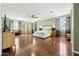 Large main bedroom with hardwood floors, ceiling fan, and sitting area at 5136 W Trotter Trl, Phoenix, AZ 85083