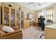 A stylish home office with built-in bookcases, a computer desk, and comfortable seating at 5136 W Trotter Trl, Phoenix, AZ 85083