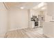 Modern white kitchen with stainless steel appliances, lots of sunlight, and updated flooring at 520 W Hononegh Dr # 2, Phoenix, AZ 85027