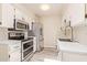 A contemporary kitchen features stainless steel appliances, bright lighting, and stylish white countertops at 520 W Hononegh Dr # 2, Phoenix, AZ 85027