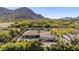 Spacious estate with pool, spa, green lawn, and basketball court, set against mountain scenery at 5615 N Invergordon Rd, Paradise Valley, AZ 85253