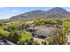 Beautiful home with a pool, green lawn, and a basketball court, set against a mountain backdrop at 5615 N Invergordon Rd, Paradise Valley, AZ 85253