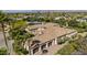Aerial shot showcases tile roof, chimneys, attached garage and mature, manicured landscaping at 5615 N Invergordon Rd, Paradise Valley, AZ 85253