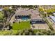 Expansive estate featuring a private pool, lush green lawn, and a basketball court at 5615 N Invergordon Rd, Paradise Valley, AZ 85253