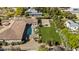 Home featuring a pool, large green lawn, basketball court, and outdoor seating area at 5615 N Invergordon Rd, Paradise Valley, AZ 85253