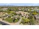 Aerial view of estate and meticulously landscaped lawn with palm trees and flowering shrubs at 5615 N Invergordon Rd, Paradise Valley, AZ 85253