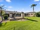 Gorgeous backyard with a lush lawn, covered patio, and desert landscaping at 5615 N Invergordon Rd, Paradise Valley, AZ 85253
