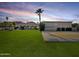 Expansive backyard with lush green lawn and mountain views, featuring a patio area at 5615 N Invergordon Rd, Paradise Valley, AZ 85253