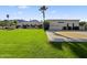 Lovely backyard with a lush lawn, beautiful desert landscaping, and a basketball court at 5615 N Invergordon Rd, Paradise Valley, AZ 85253