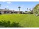 Expansive backyard featuring a lush lawn, basketball court, and desert landscaping at 5615 N Invergordon Rd, Paradise Valley, AZ 85253
