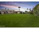 Lush backyard with a large green lawn and a covered patio, ideal for outdoor activities and relaxation at 5615 N Invergordon Rd, Paradise Valley, AZ 85253