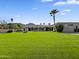 Expansive backyard featuring a lush lawn, mature trees, and desert landscaping with a mountain view at 5615 N Invergordon Rd, Paradise Valley, AZ 85253