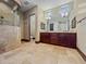 The luxurious bathroom boasts a glass shower, dual sinks, large vanity, and a neutral color scheme at 5615 N Invergordon Rd, Paradise Valley, AZ 85253