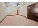 Spacious bedroom with neutral tones, carpeted flooring, trimwork, and access to what appears to be a walk-in closet at 5615 N Invergordon Rd, Paradise Valley, AZ 85253
