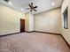 Spacious bedroom with neutral tones, carpeted flooring, trimwork, and a ceiling fan with decorative light fixture at 5615 N Invergordon Rd, Paradise Valley, AZ 85253