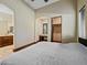 A comfortable bedroom with a bed, walk-in closet, desk area, and attached bathroom for convenience at 5615 N Invergordon Rd, Paradise Valley, AZ 85253