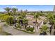 Aerial shot of a luxurious home with a tile roof, lush landscaping, and a circular driveway at 5615 N Invergordon Rd, Paradise Valley, AZ 85253