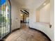 Spacious home foyer featuring travertine floors and arched openings at 5615 N Invergordon Rd, Paradise Valley, AZ 85253
