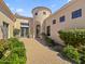 Charming home with a turret entryway, manicured landscaping, and a brick pathway at 5615 N Invergordon Rd, Paradise Valley, AZ 85253