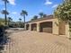 Close-up of the exterior three-car garage with paver driveway at 5615 N Invergordon Rd, Paradise Valley, AZ 85253