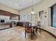 A kitchen and dining area boasting stainless steel appliances, wood cabinets, and stone tile floors at 5615 N Invergordon Rd, Paradise Valley, AZ 85253