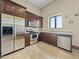 A view of a modern kitchen with stainless steel appliances, granite countertops and dark wood cabinetry at 5615 N Invergordon Rd, Paradise Valley, AZ 85253