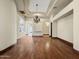 Bright living room with wood floors, archways, tray ceilings, and elegant lighting at 5615 N Invergordon Rd, Paradise Valley, AZ 85253