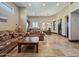 An open living area flows into a kitchen and dining space, complete with stone floors and recessed lighting at 5615 N Invergordon Rd, Paradise Valley, AZ 85253