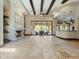 Living room featuring a fireplace, beamed ceilings, and large sliding doors to the outdoors at 5615 N Invergordon Rd, Paradise Valley, AZ 85253