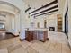 Entertain in the luxurious living room, boasting high ceilings, stone floors, a fireplace, and a modern wet bar at 5615 N Invergordon Rd, Paradise Valley, AZ 85253