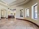 The wide open living room features stone floors, and views to a wet bar with a stainless steel mini-refrigerator at 5615 N Invergordon Rd, Paradise Valley, AZ 85253