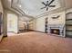 Expansive living room with a fireplace and a chandelier, showcasing the home's grandeur at 5615 N Invergordon Rd, Paradise Valley, AZ 85253