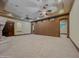 Large living room with a stone fireplace, ceiling fans, and neutral tones at 5615 N Invergordon Rd, Paradise Valley, AZ 85253