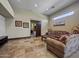 A bright living room features stone floors, recessed lighting, neutral walls, and a pocket door to another room at 5615 N Invergordon Rd, Paradise Valley, AZ 85253