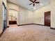 Spacious primary bedroom boasts neutral tones, carpeted flooring, trimwork, and an ensuite bathroom at 5615 N Invergordon Rd, Paradise Valley, AZ 85253