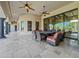 Covered patio with dining table, seating, and multiple ceiling fans at 5615 N Invergordon Rd, Paradise Valley, AZ 85253