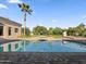 Backyard pool with jacuzzi, desert landscaping, a lush lawn, and a palm tree at 5615 N Invergordon Rd, Paradise Valley, AZ 85253