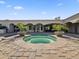 A gorgeous backyard pool with an attached jacuzzi, surrounded by lush landscaping at 5615 N Invergordon Rd, Paradise Valley, AZ 85253