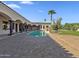 Stunning backyard pool with pillars, a covered patio, and lush green grass at 5615 N Invergordon Rd, Paradise Valley, AZ 85253