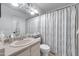 Bright bathroom featuring a neutral vanity, a large mirror, and a shower with a striped curtain for a clean aesthetic at 5704 E Aire Libre Ave # 1246, Scottsdale, AZ 85254