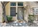 Inviting front entrance with a gray door, decorative window, charming lantern, and stone walkway at 5704 E Aire Libre Ave # 1246, Scottsdale, AZ 85254