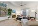 Bright living room featuring a fireplace, high ceilings, large windows, and comfortable seating at 5704 E Aire Libre Ave # 1246, Scottsdale, AZ 85254