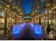 Palm tree-lined outdoor mall with illuminated fountains and inviting seating areas for a vibrant shopping experience at 5704 E Aire Libre Ave # 1246, Scottsdale, AZ 85254