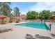 Community pool area with lounge chairs, a tiled roof cabana and mature trees in a well maintained setting at 5704 E Aire Libre Ave # 1246, Scottsdale, AZ 85254